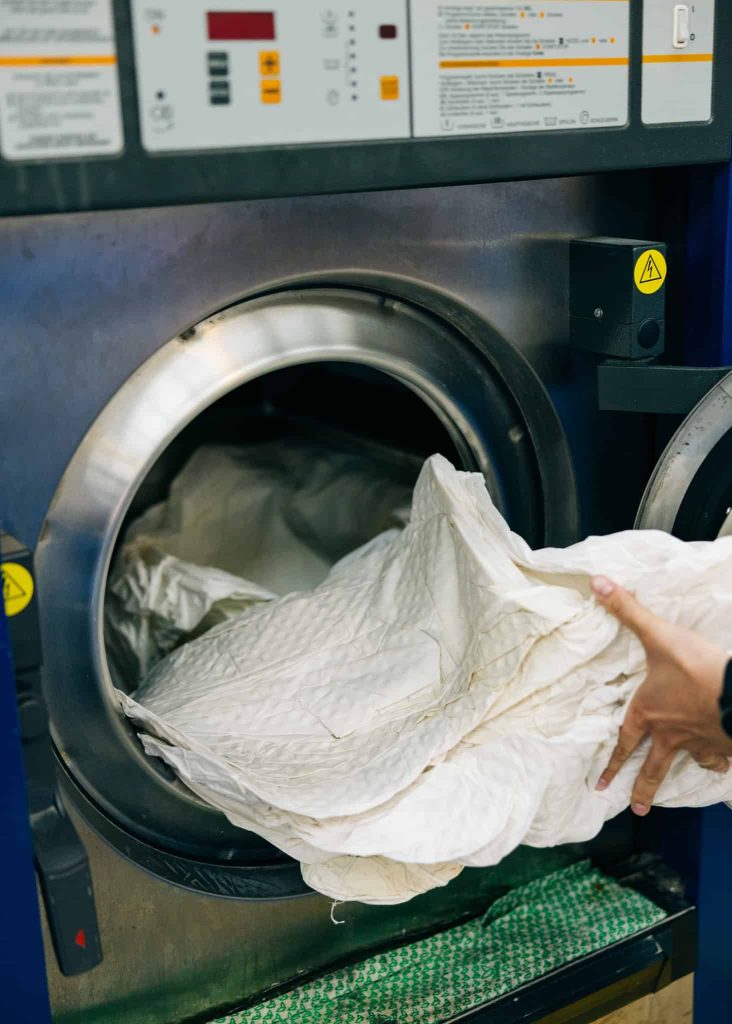 Bij een professionele donsdekenreiniging gebeurt het wassen van de dons en de tijk apart.